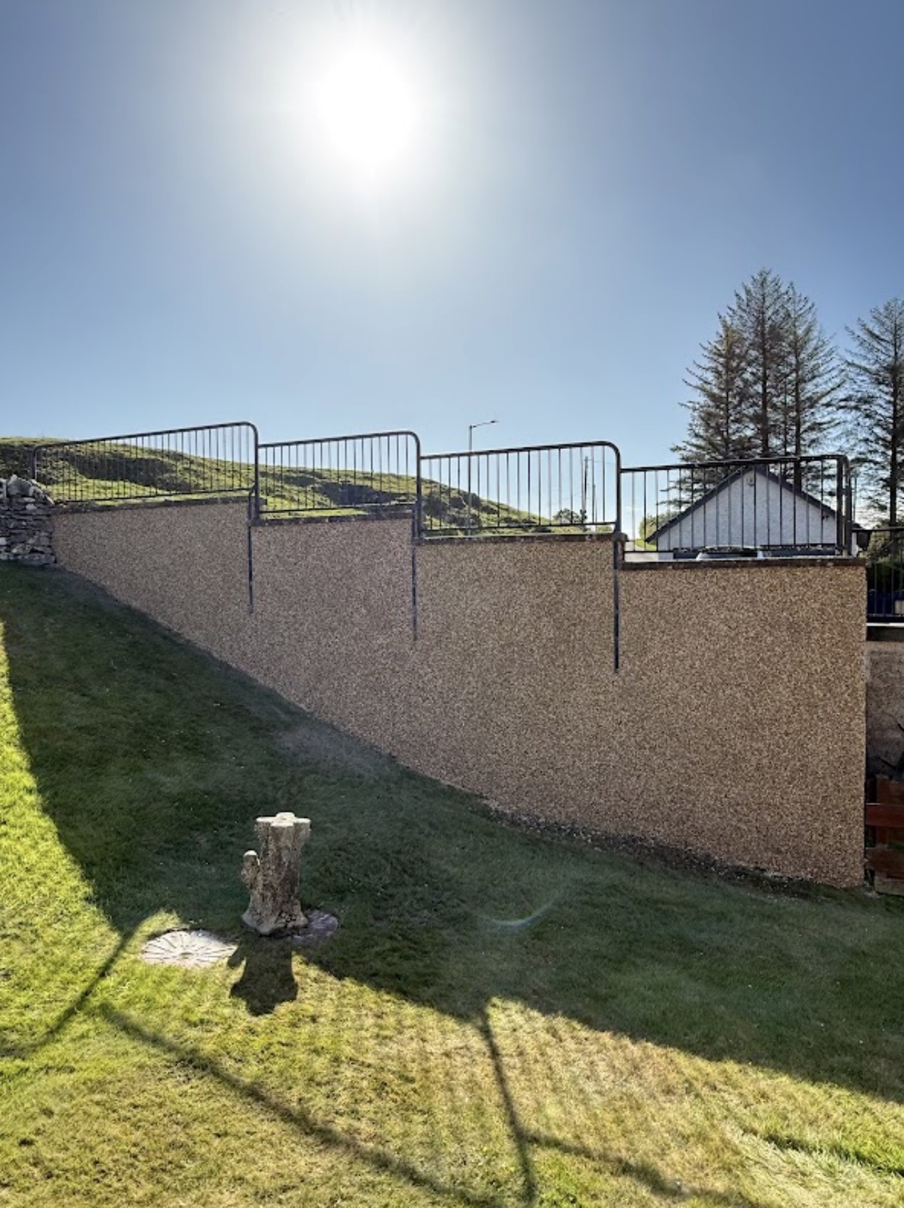 Roughcast retaining garden wall